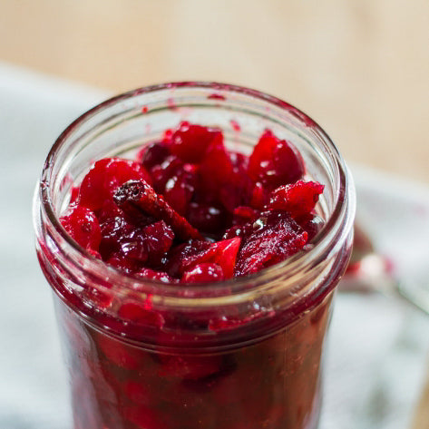chunky cranberry sauce in a glass jar