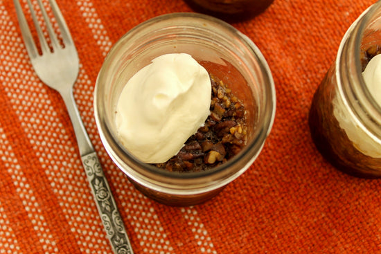 single serving pecan pies in canning jars topped with whipped cream